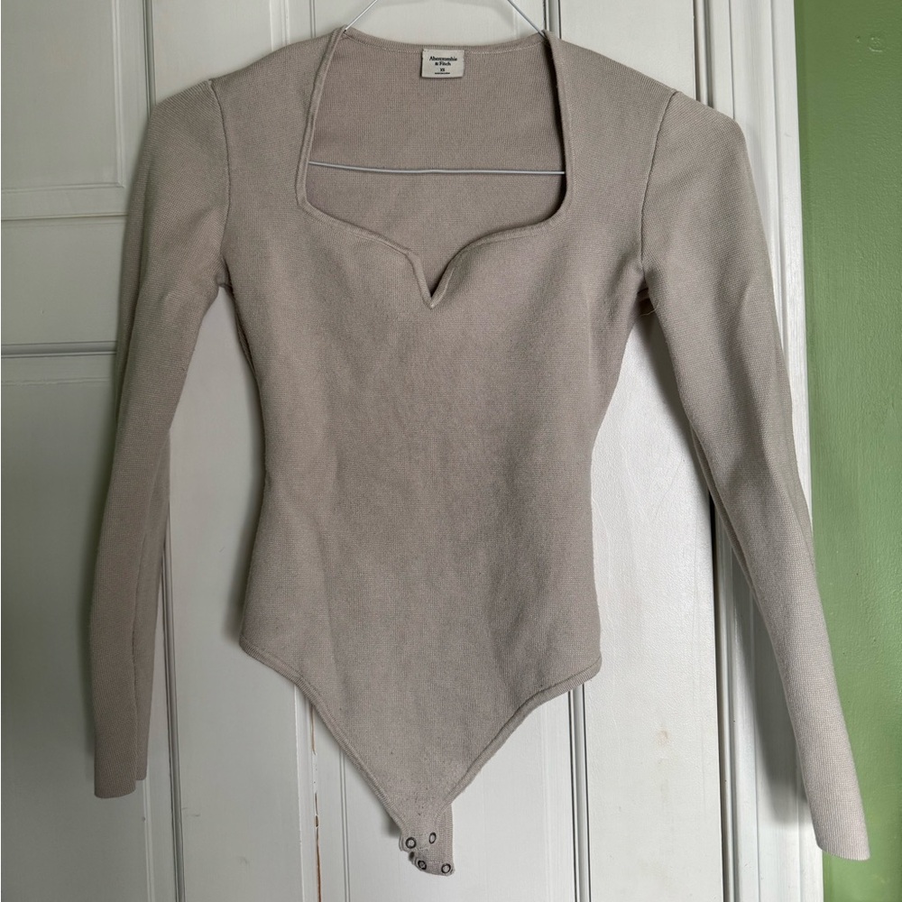 Size XS, light tan color, thick knit fabric, light worn